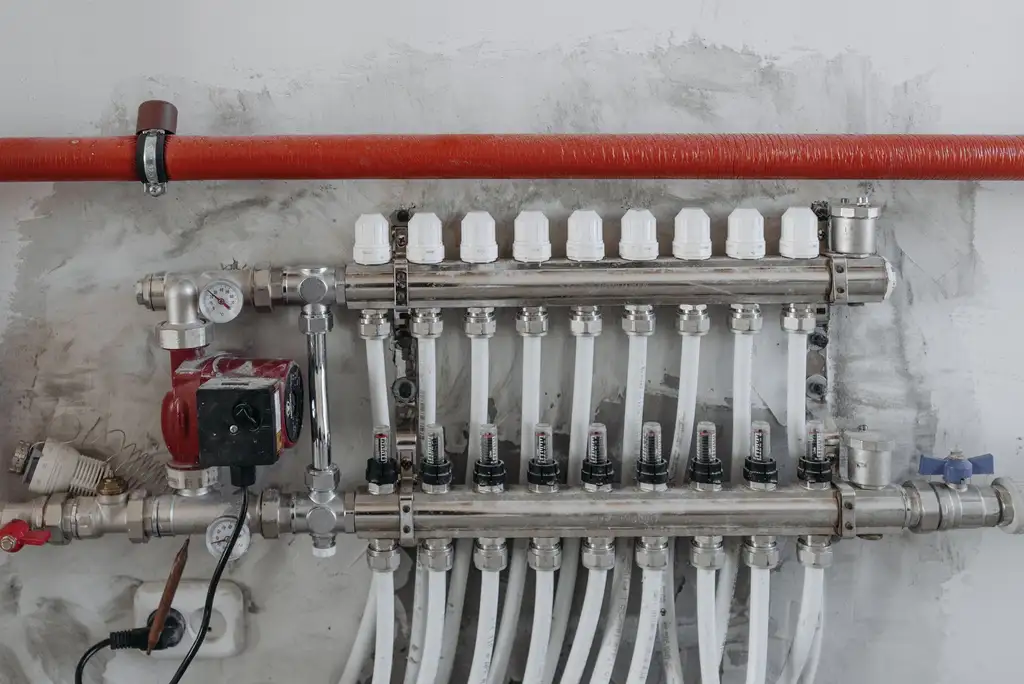A heating and water manifold with labelled circuits and isolation valves